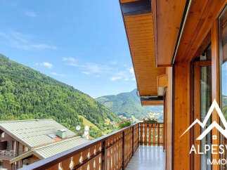 Experience breathtaking mountain views from this charming wooden balcony, perfect for enjoying your morning coffee or evening relaxation.