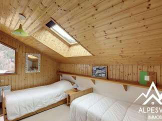 Discover this charming attic bedroom featuring two comfortable twin beds, perfect for guests or family.