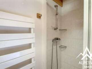 This bathroom features a modern white towel warmer, perfect for keeping your towels cozy.