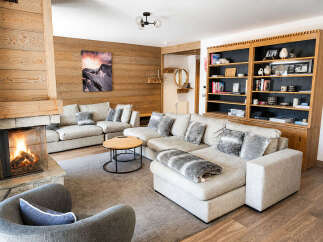 Experience ultimate relaxation in this cozy living room, featuring a crackling fireplace and plush sectional sofa perfect for gathering with loved ones.