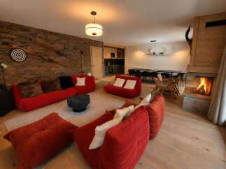 Experience ultimate comfort and style in this luxurious living room, featuring plush red modular sofas perfect for relaxation.