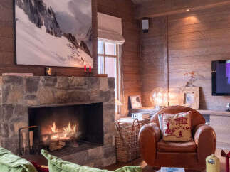 Experience rustic charm in this inviting living room, featuring a magnificent stone fireplace as the centerpiece.