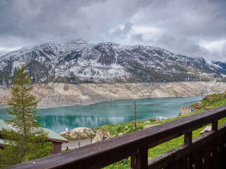 Experience breathtaking mountain views from this charming property, featuring a serene lake and snow-capped peaks.