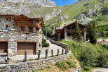 Discover this stunning mountain chalet, featuring traditional stone and wood architecture, perfect for a luxurious alpine retreat.