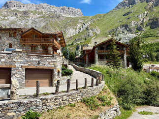 Discover this stunning mountain chalet, featuring traditional stone and wood architecture, perfect for a luxurious alpine retreat.