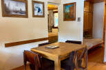 This charming property features a cozy dining area with a wooden table and chairs, perfect for intimate meals.