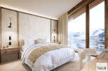 Experience luxury mountain living in this stunning bedroom featuring a plush king-sized bed and a cozy throw.