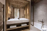 Experience luxury in this modern bathroom featuring a double vanity with a marble countertop and ample storage.