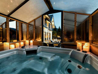 Indulge in ultimate relaxation in this luxurious jacuzzi, surrounded by the warm glow of ambient lighting.