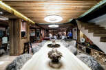 Experience luxury mountain living in this stunning chalet, featuring a grand live-edge dining table perfect for entertaining.