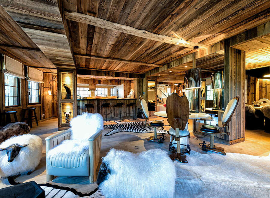 Experience rustic luxury in this stunning chalet-style living space, featuring a full-service bar and ample seating.