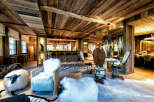 Experience rustic luxury in this stunning chalet-style living space, featuring a full-service bar and ample seating.