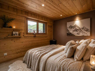 Experience cozy mountain living in this charming bedroom, featuring warm wood paneling throughout and a stunning panoramic view from the window.
