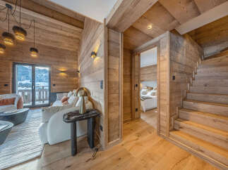 Experience luxurious mountain living in this stunning chalet, featuring a cozy living area with a fireplace and breathtaking views.