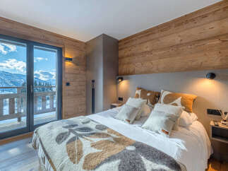 Experience ultimate comfort in this charming bedroom, featuring a cozy bed adorned with plush pillows and a decorative throw.