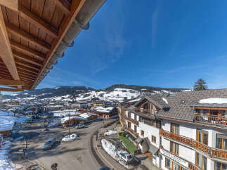 Experience the charm of this alpine village with a stunning view of snow-capped mountains and a bustling town center.