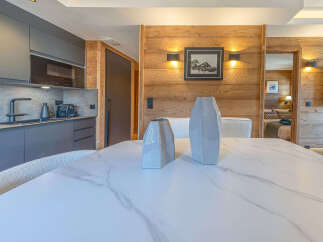 Experience modern living in this beautifully appointed apartment, featuring a sleek, contemporary kitchen with integrated appliances and a stylish stone backsplash.