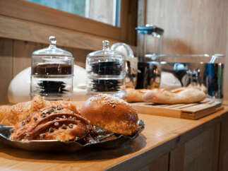 Start your day with a delightful breakfast spread, featuring freshly baked croissants and artisanal bread, perfect for a cozy morning in.