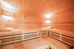 Experience ultimate relaxation in this luxurious wooden sauna, featuring multiple tiers of comfortable seating perfect for unwinding.