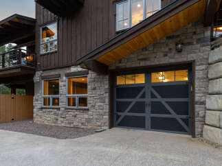 Experience modern mountain living in this stunning home featuring a striking stone and wood exterior.