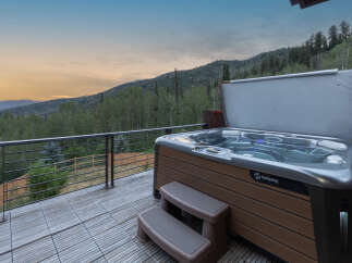Experience ultimate relaxation with this luxurious Hot Spring spa, perfectly situated on a spacious deck with breathtaking mountain views.