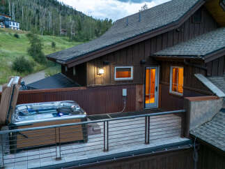 Experience ultimate relaxation in this stunning mountain home, featuring a luxurious hot tub on a private deck with breathtaking views.