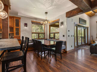 Experience rustic charm and modern comfort in this inviting dining area, featuring a spacious wooden table with plush seating and a cozy banquette.