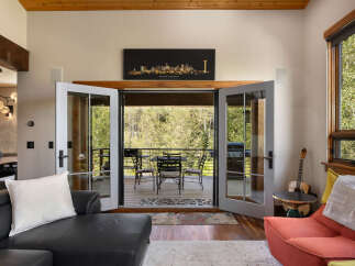 Experience seamless indoor-outdoor living with this stunning property, featuring double doors that open onto a spacious deck perfect for entertaining.