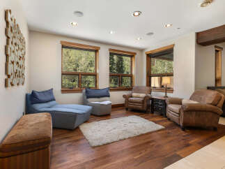 Experience ultimate relaxation in this inviting living space, featuring plush seating options and large windows that offer serene views of the surrounding nature.