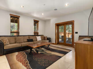 This inviting living room features a spacious sectional sofa with plush cushions and a stylish coffee table, perfect for gatherings.