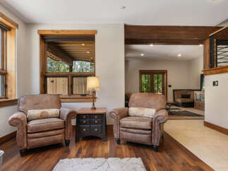 Experience rustic charm in this inviting living space, featuring two plush leather armchairs perfect for relaxation.