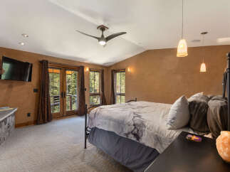 Experience ultimate comfort in this luxurious bedroom, featuring a king-sized bed with elegant marble-patterned bedding.