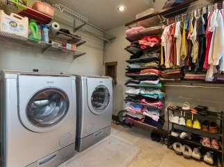 Discover the ultimate laundry room with a spacious walk-in closet, perfect for organizing all your essentials.