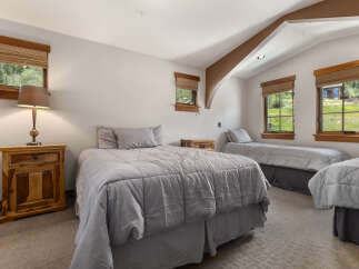 This charming bedroom features multiple beds, perfect for accommodating family or guests.