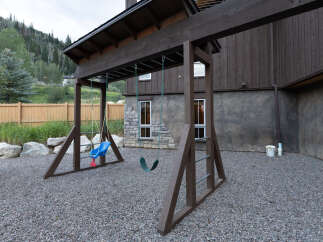 Enjoy outdoor fun with this charming swing set, perfect for a family-friendly backyard.