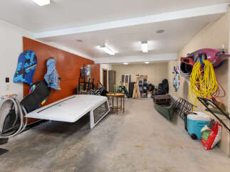 This spacious garage offers ample storage for all your recreational gear, including kayaks, snowboards, and a canoe.