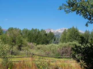 Experience the serene beauty of this property, nestled amidst lush greenery and overlooking majestic mountains.