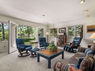 Step into this inviting living room, featuring comfortable blue leather recliners and a patterned sofa perfect for relaxation.