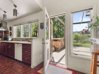 Step into this charming kitchen, featuring rich cherry wood cabinets and a spacious sink area, perfect for meal preparation.