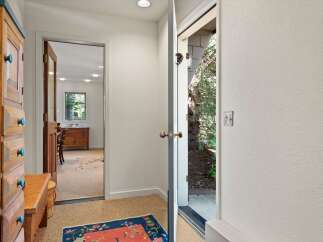 Step into this charming entryway featuring a rustic wooden cabinet with unique turquoise knobs, perfect for storage.
