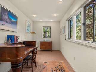 This home office features a large wooden desk with a curved front, perfect for a productive workspace.