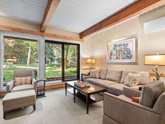 Experience comfort and style in this inviting living room, featuring a plush sofa and accent chairs perfect for relaxation.