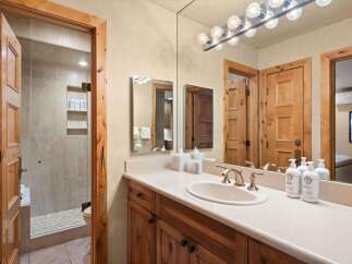 This charming bathroom features a spacious vanity with a double sink and ample counter space, perfect for morning routines.