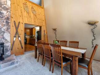 Experience rustic charm in this dining area, featuring a warm wooden dining table with six chairs, perfect for family gatherings.