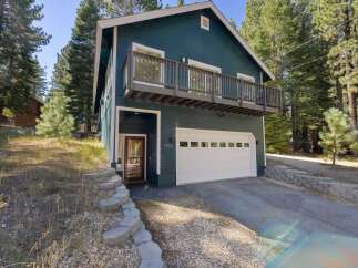 Discover this charming home featuring a spacious two-car garage and a welcoming front entrance.
