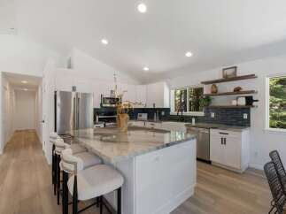 Experience modern living in this stunning kitchen featuring a spacious island with a marble countertop, perfect for meal prep and entertaining.
