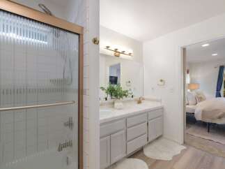 This beautifully updated bathroom features a spacious walk-in shower with a glass enclosure and elegant tile work.