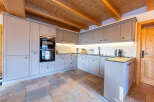 Experience modern alpine living in this beautifully appointed kitchen, featuring sleek grey cabinetry and integrated appliances.