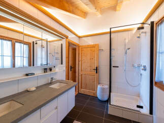 Experience modern comfort in this beautifully appointed bathroom, featuring a spacious double vanity with sleek countertops and ample storage.