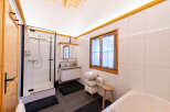 Experience modern comfort in this beautifully appointed bathroom, featuring a spacious glass-enclosed shower and a sleek vanity with ample storage.